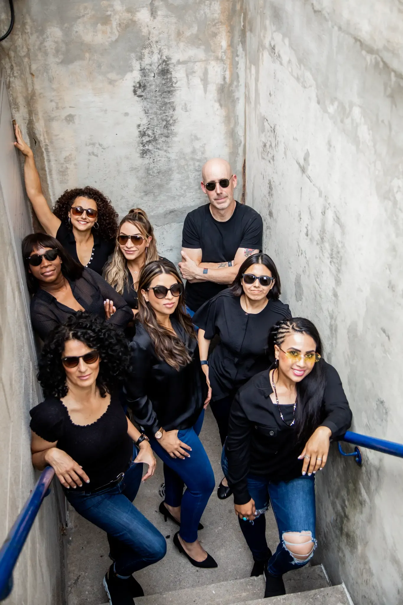 Dr. Noah Belman and the Belman Dental Centre team posing together on a stairway